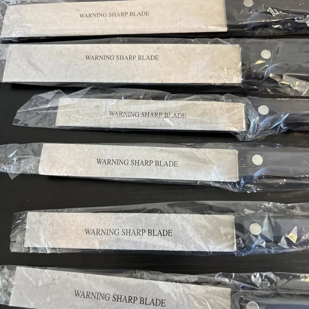 14 Piece serrated stainless steel blades and black handles with triple rivets